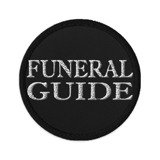 Circular embroidered patch featuring Funeral Guide, front view