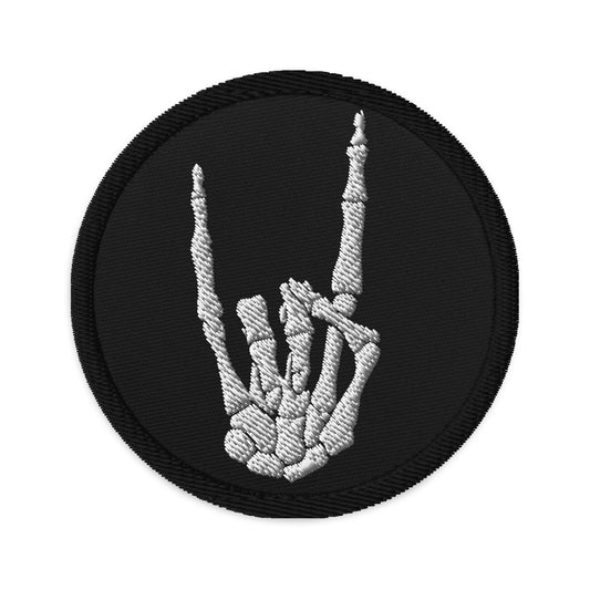 Circular embroidered patch featuring Devil Horns Bone Hand, front view