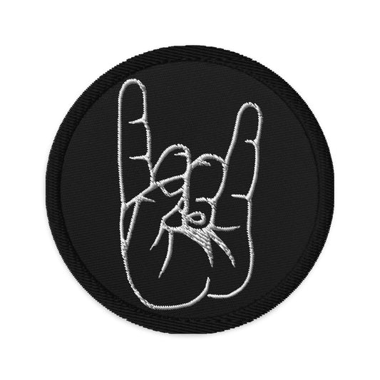 Circular embroidered patch featuring The Sign of the Horns, front view
