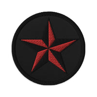 Circular embroidered patch featuring Black Nautical Star North Star, front view