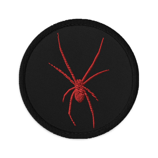 Circular embroidered patch featuring Red Arachnid Creepy Black Widow Spider, front view