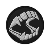 Circular embroidered patch featuring Vampire Fangs Novelty Halloween Toy Trick or Treat, front view