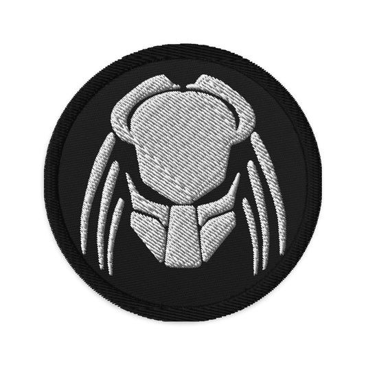 Circular embroidered patch featuring Predator Alien Hybrid, front view
