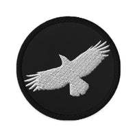 Circular embroidered patch featuring Flying Raven Black Bird, front view
