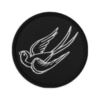 Circular embroidered patch featuring Falling Sparrow Tattoo Style Bird, front view