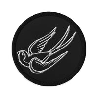 Circular embroidered patch featuring Falling Sparrow Tattoo Style Bird, front view