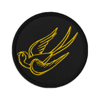 Circular embroidered patch featuring Falling Sparrow Tattoo Style Bird, front view