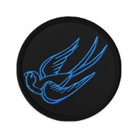 Circular embroidered patch featuring Falling Sparrow Tattoo Style Bird, front view