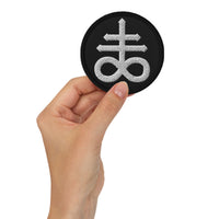 Circular embroidered patch featuring White The Leviathan Cross of Satan, front view