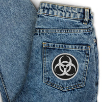 Circular embroidered patch featuring White Thread Bio Hazard Symbol Warning Sign, front view