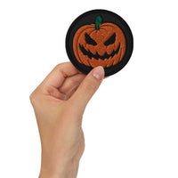 Circular embroidered patch featuring Scary Jack O Lantern Halloween Pumpkin, front view