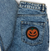 Circular embroidered patch featuring Scary Jack O Lantern Halloween Pumpkin, front view