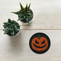 Circular embroidered patch featuring Scary Jack O Lantern Halloween Pumpkin, front view