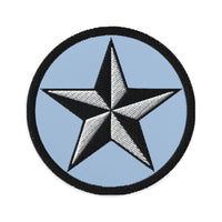 Circular embroidered patch featuring Black Nautical Star North Star, front view