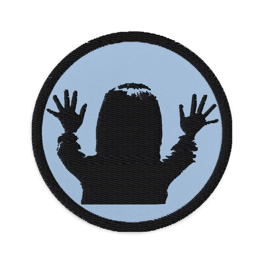 Circular embroidered patch featuring "They're Here" Carol Anne Poltergeist, front view