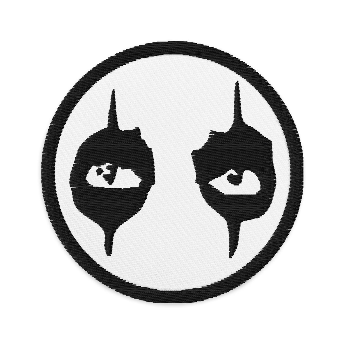 Circular embroidered patch featuring Black Eyeliner The Eyes of Alice Cooper, front view