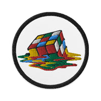 Circular embroidered patch featuring Melting Speed Cube Gaming Puzzle Box, front view
