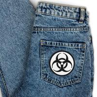 Circular embroidered patch featuring Black Thread Bio Hazard Symbol Warning Sign, front view