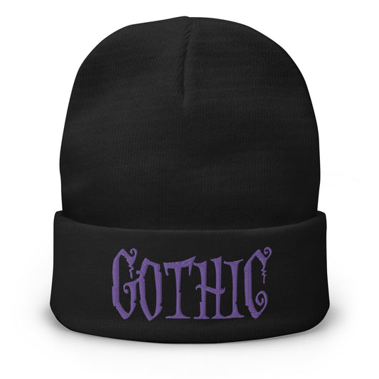 Black cuffed beanie with Dramatic embroidered artwork, front view
