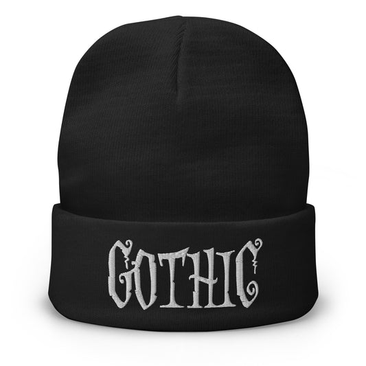 Black cuffed beanie with Dramatic embroidered artwork, front view