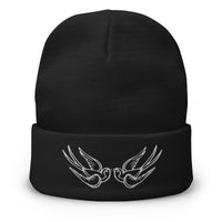 Black cuffed beanie with Falling Sparrows Tattoo Bird embroidered artwork, front view