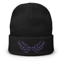 Black cuffed beanie with Falling Sparrows Tattoo Bird embroidered artwork, front view